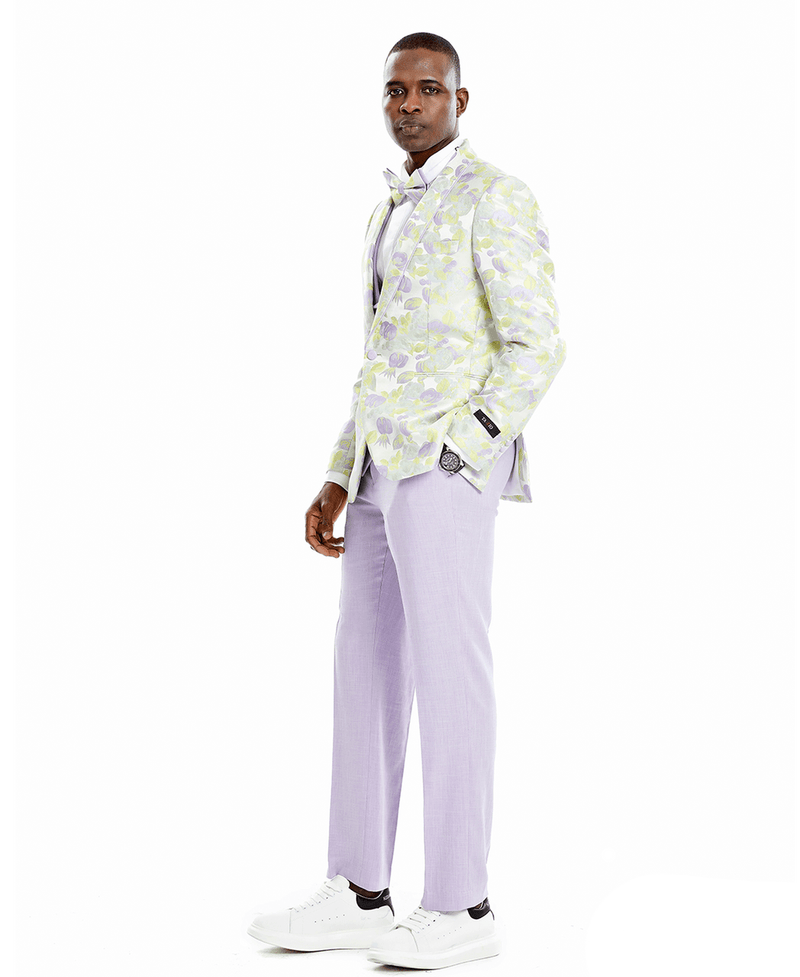 A man wearing a 3-piece suit. Floral patterned jacket, solid colored vest and pants. Bowtie matches floral jacket.